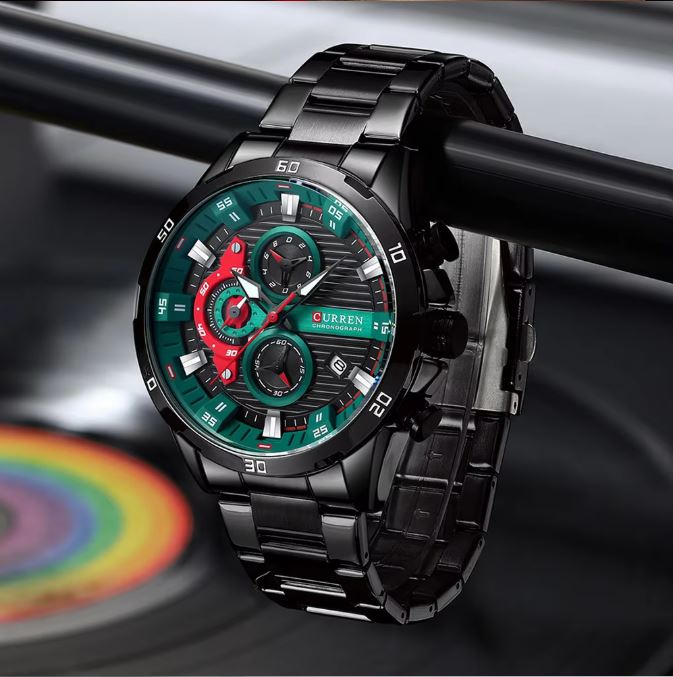 Luxury watch with a black strap and colorful face on a blurred background