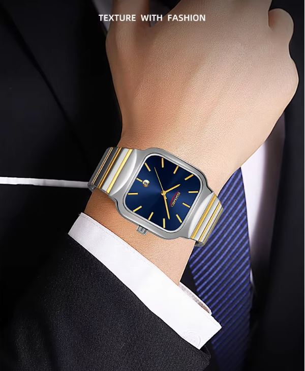 Luxury watch on a person's wrist with a suit and tie in the background