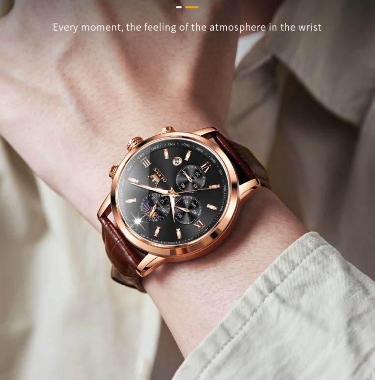 Luxury watch with brown leather strap and rose gold case on wrist against neutral background