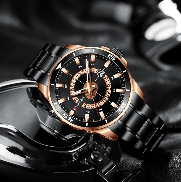 Luxury watch with black and rose gold design on a dark background