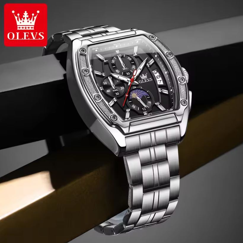 Silver OLEVS watch with detailed face on a dark background