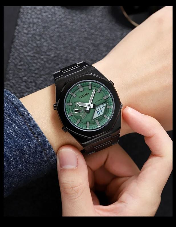 Person wearing a black watch with a green face on a wrist.
