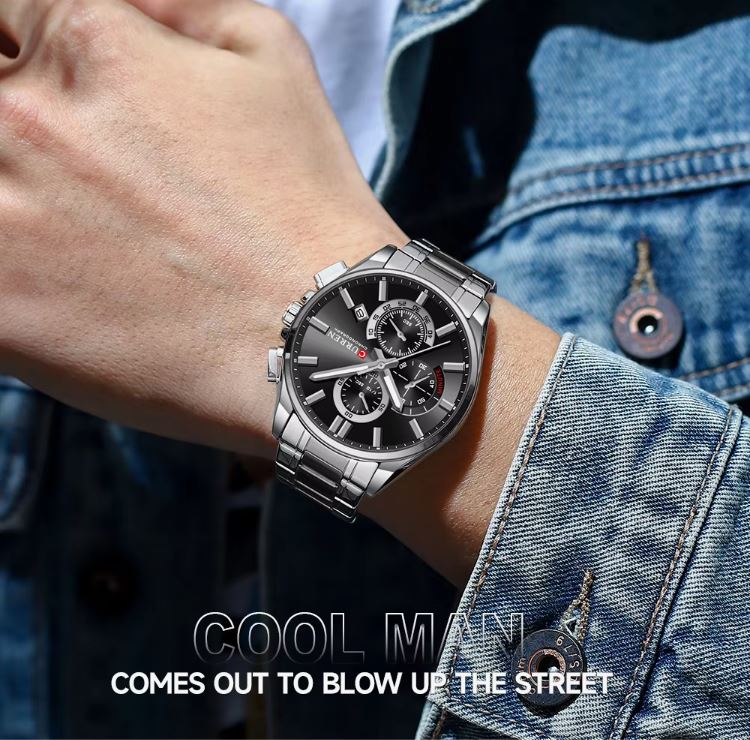 Person wearing a silver wristwatch with a denim jacket, text 'COOL MAN COMES OUT TO BLOW UP THE STREET'.