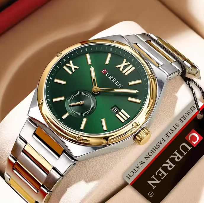 Green watch with gold and silver accents on a beige surface, accompanied by a Curren branded box.