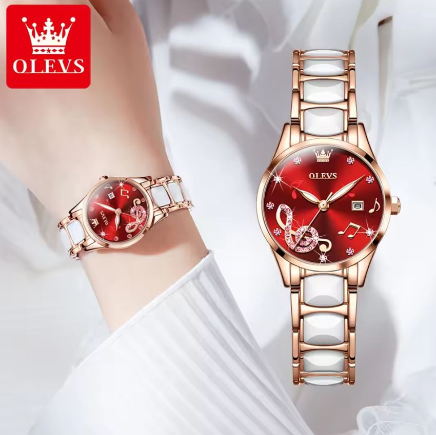 Rose gold and white watch with red face on wrist, OLEVS brand visible