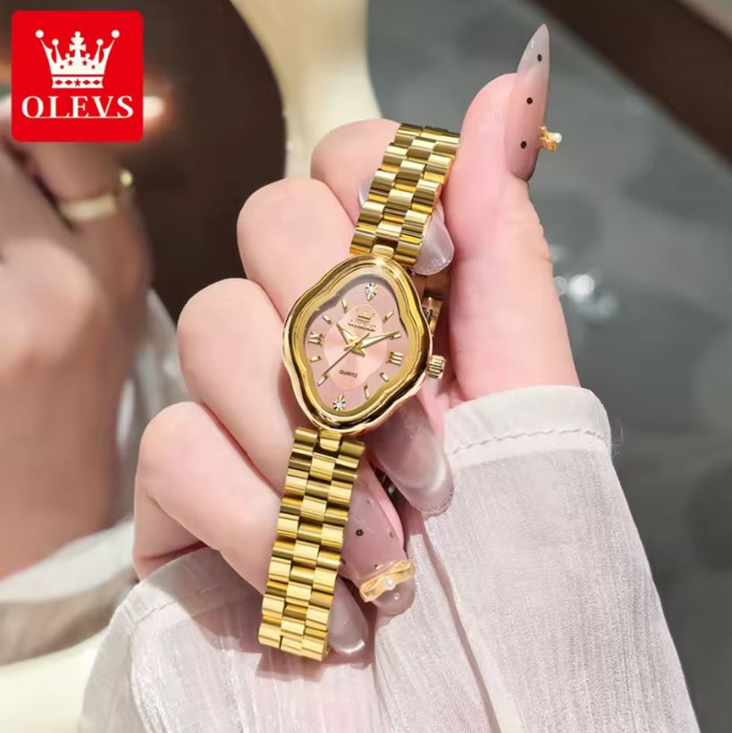 Gold watch held in a hand with OLEVS logo in the corner