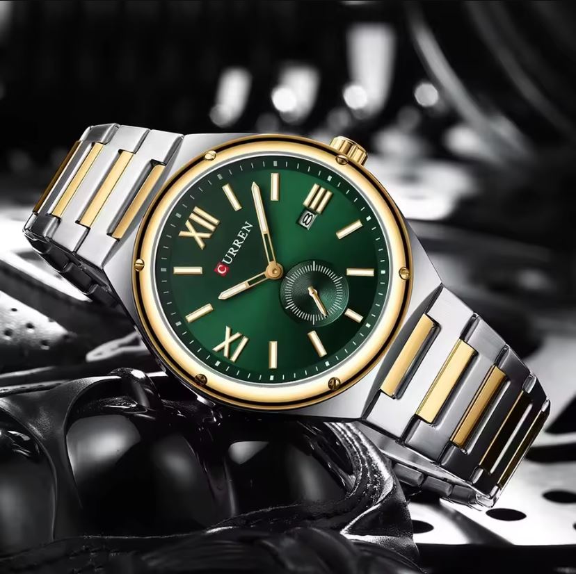 Luxury watch with green dial and gold accents on a dark background