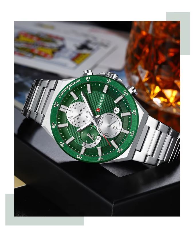 Green watch with silver strap on a dark surface