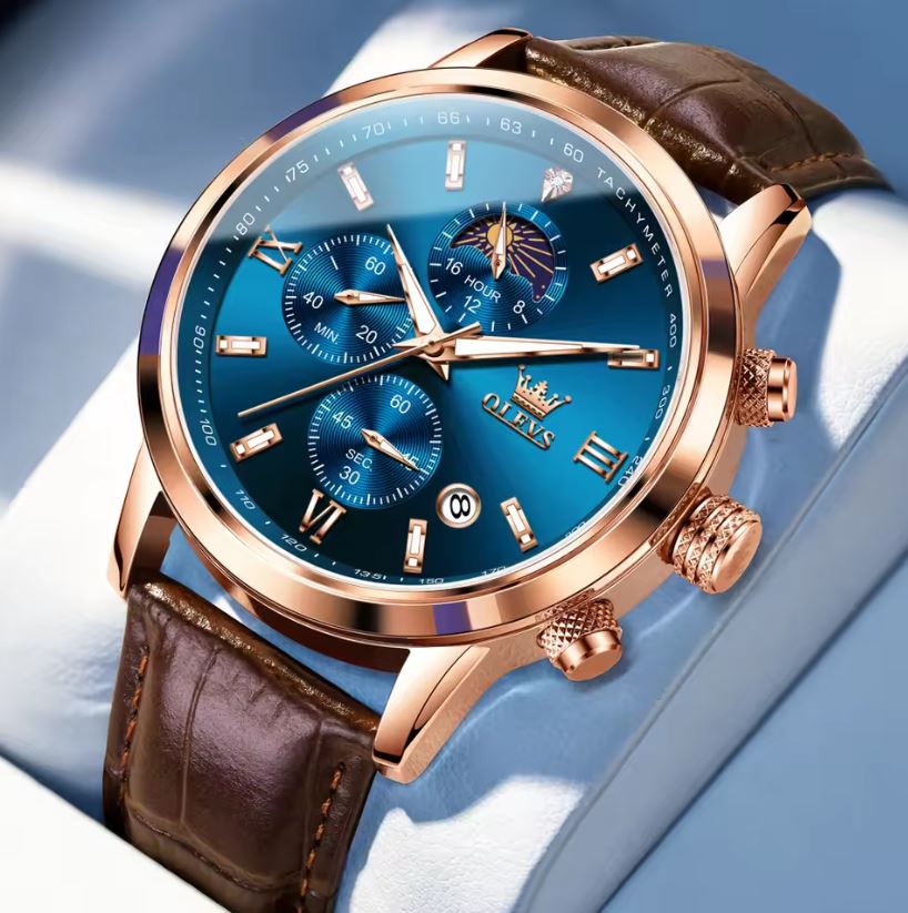 Luxury watch with blue face and brown leather strap on a light blue background
