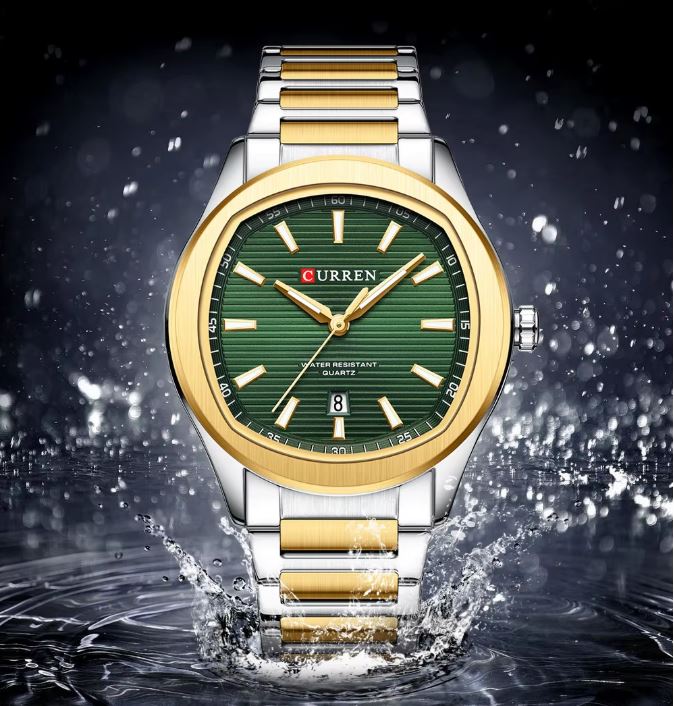 Curren watch with gold and silver band on a dark water background