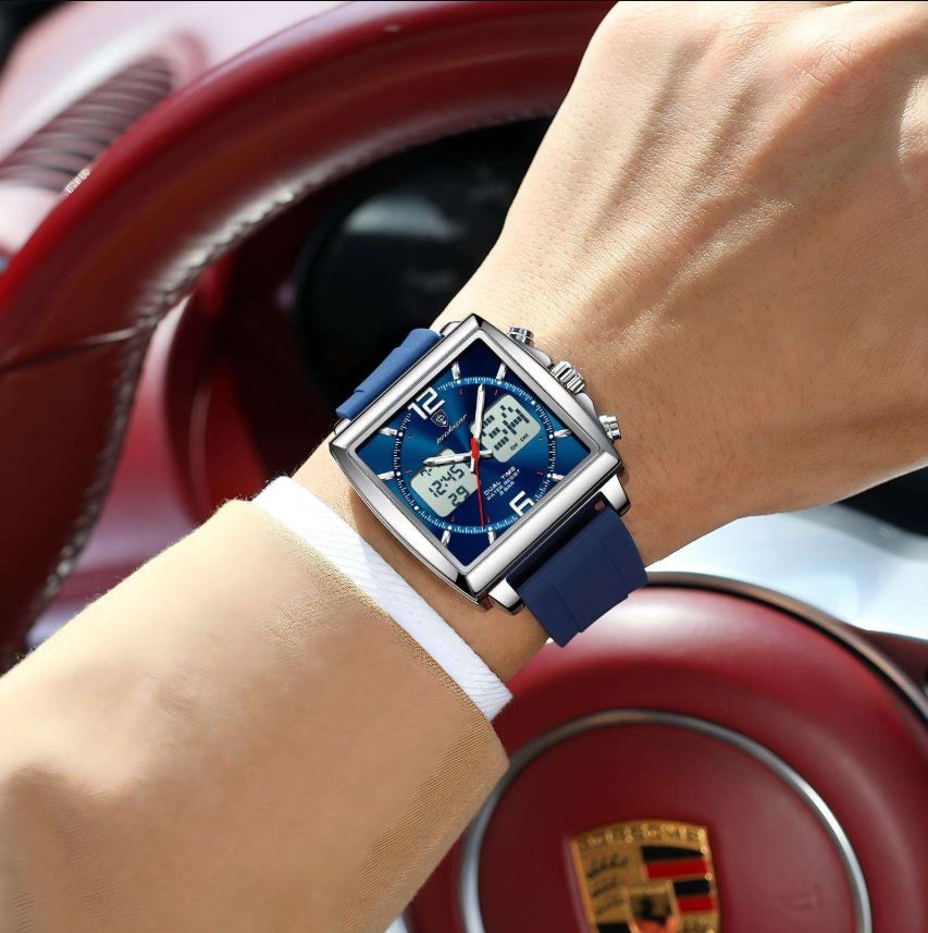 Blue wristwatch on a person's wrist with a red car interior in the background