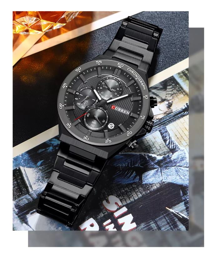 Black wristwatch with detailed face on a textured surface