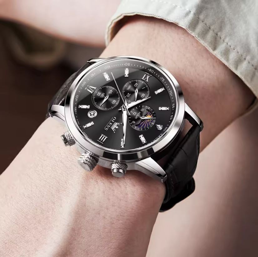 Luxury watch with black dial and leather strap on a wrist