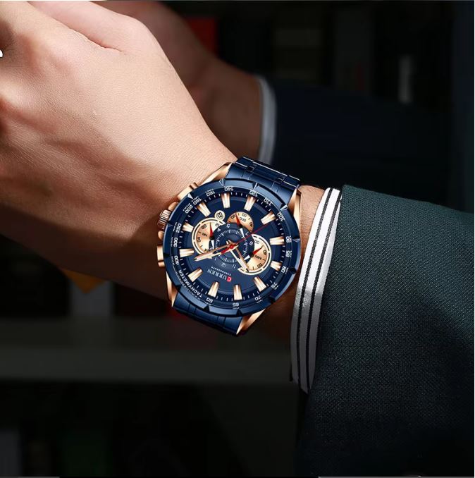 Blue and rose gold watch on a person's wrist with a dark background