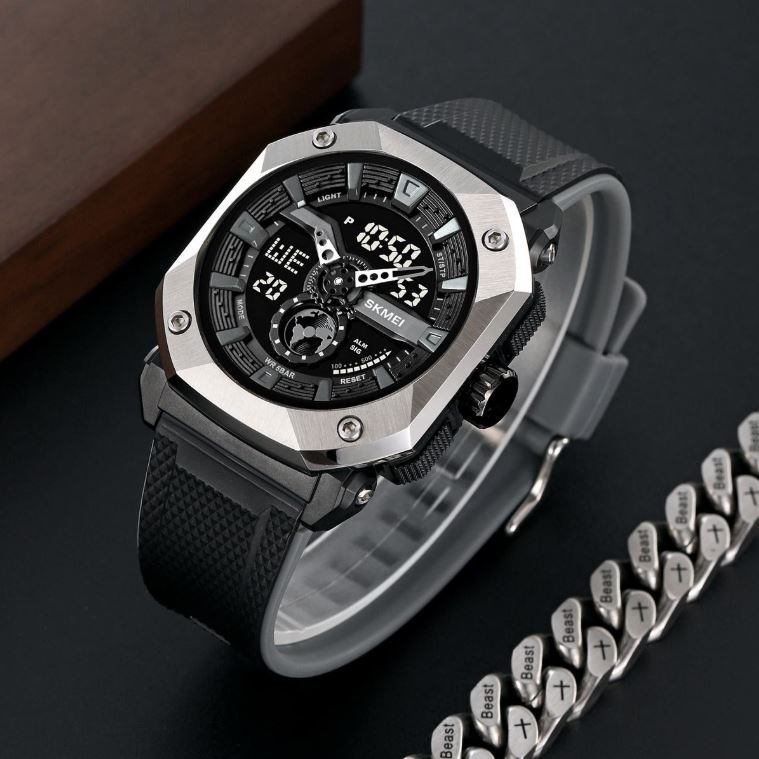 Black and silver watch with digital display on a dark surface