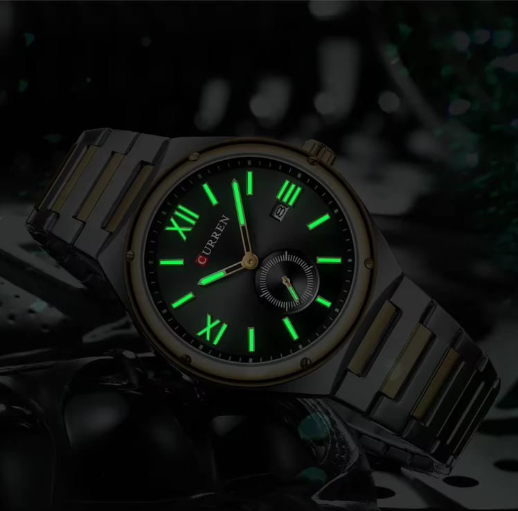 Watch with green glowing face and black strap on dark background