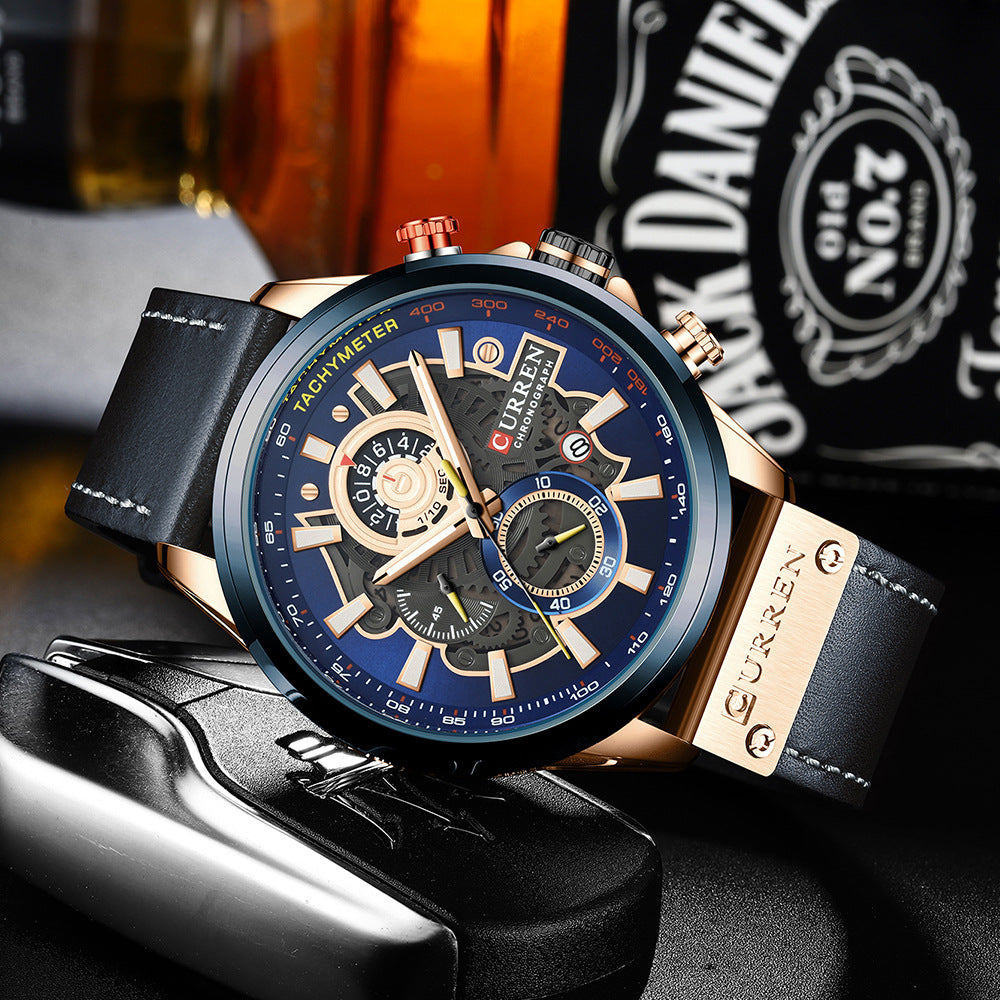 Luxury watch with blue dial and black leather strap on a dark background