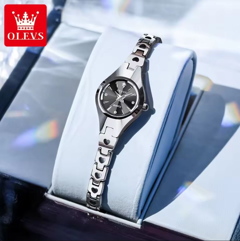 Silver watch on a white cushion with OLEVS logo in the corner