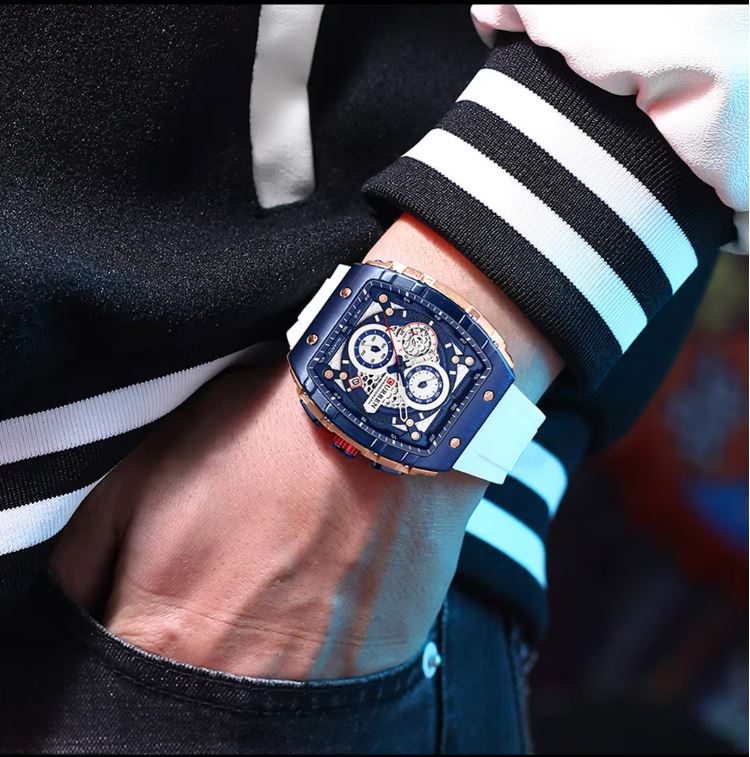 Close-up of a person wearing a detailed wristwatch with a black and white striped sleeve.