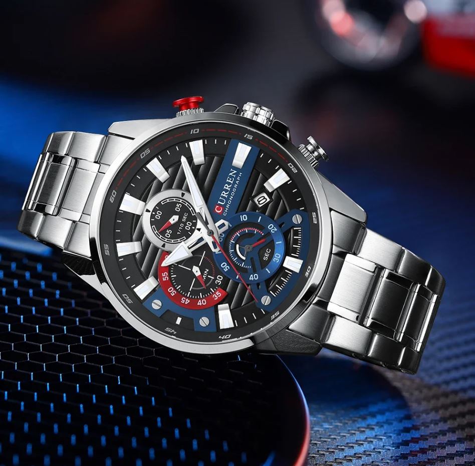 Silver wristwatch with a detailed face on a dark background