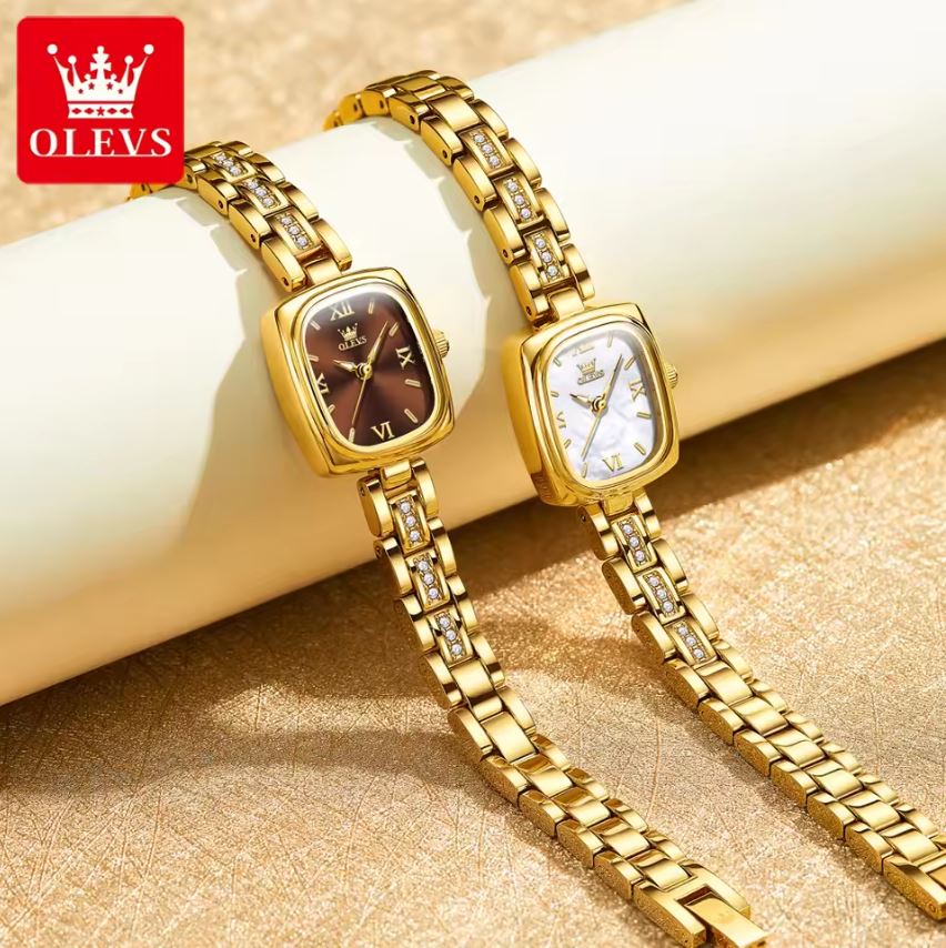 Two gold wristwatches on a beige surface with OLEVS logo.