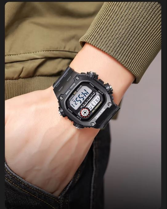 Black digital watch on a wrist with a neutral background