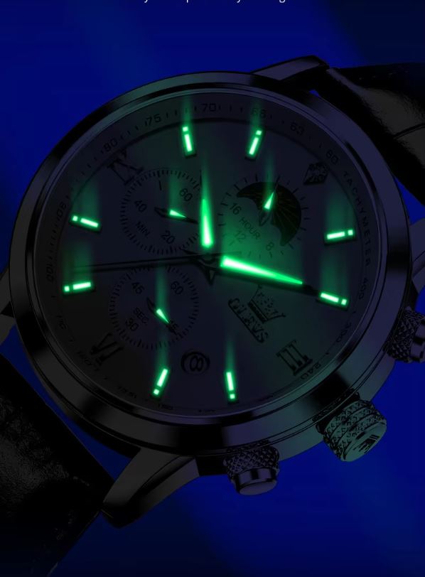 Watch with glowing green faces on a dark background