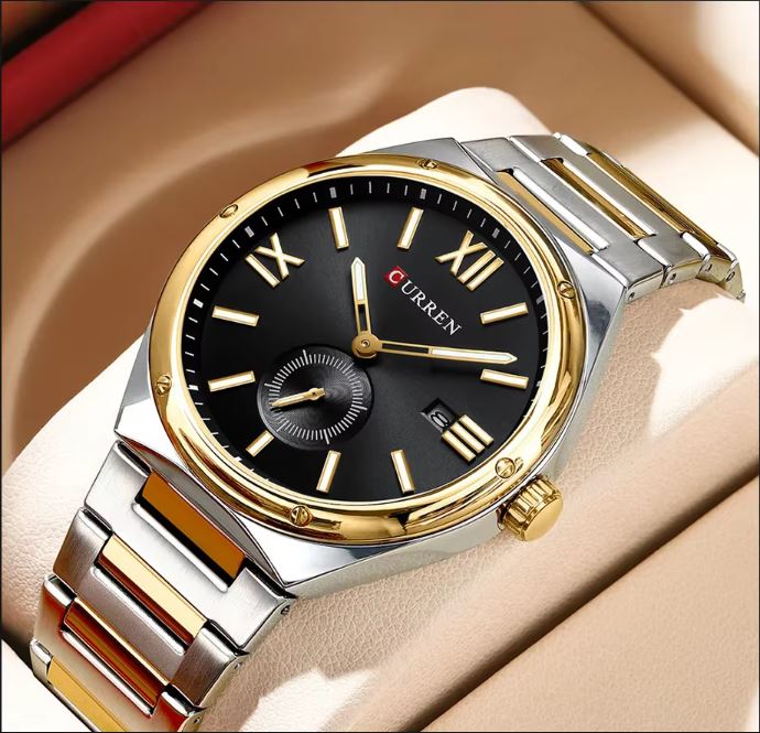 Curren watch with gold and silver band on a beige surface