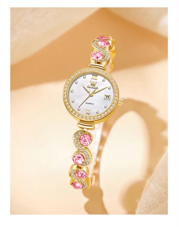 Gold wristwatch with pink gemstones on a beige background