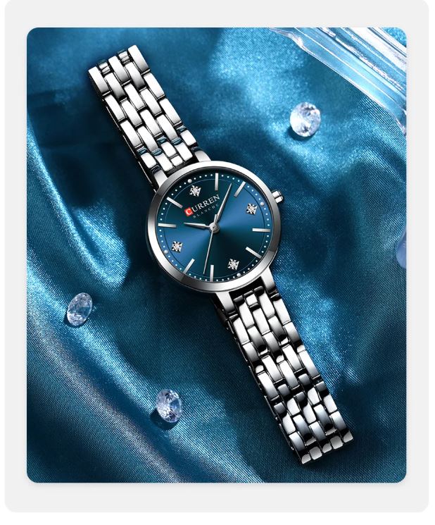 Silver watch with blue face on a blue satin background