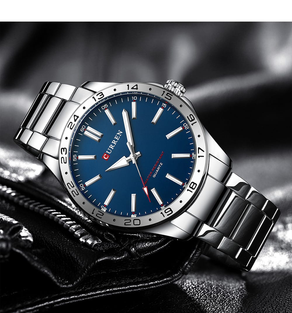Silver watch with a blue dial on a dark background