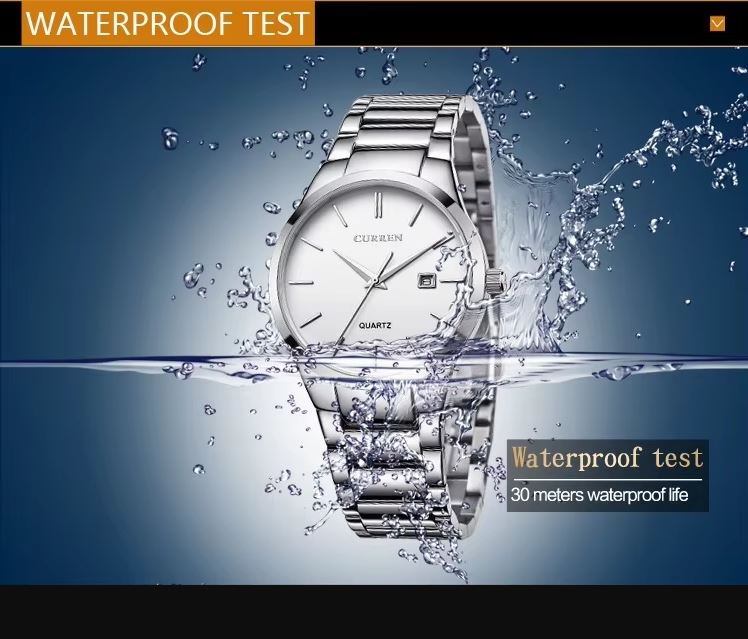 Silver watch with water splashing around it, indicating waterproof feature.