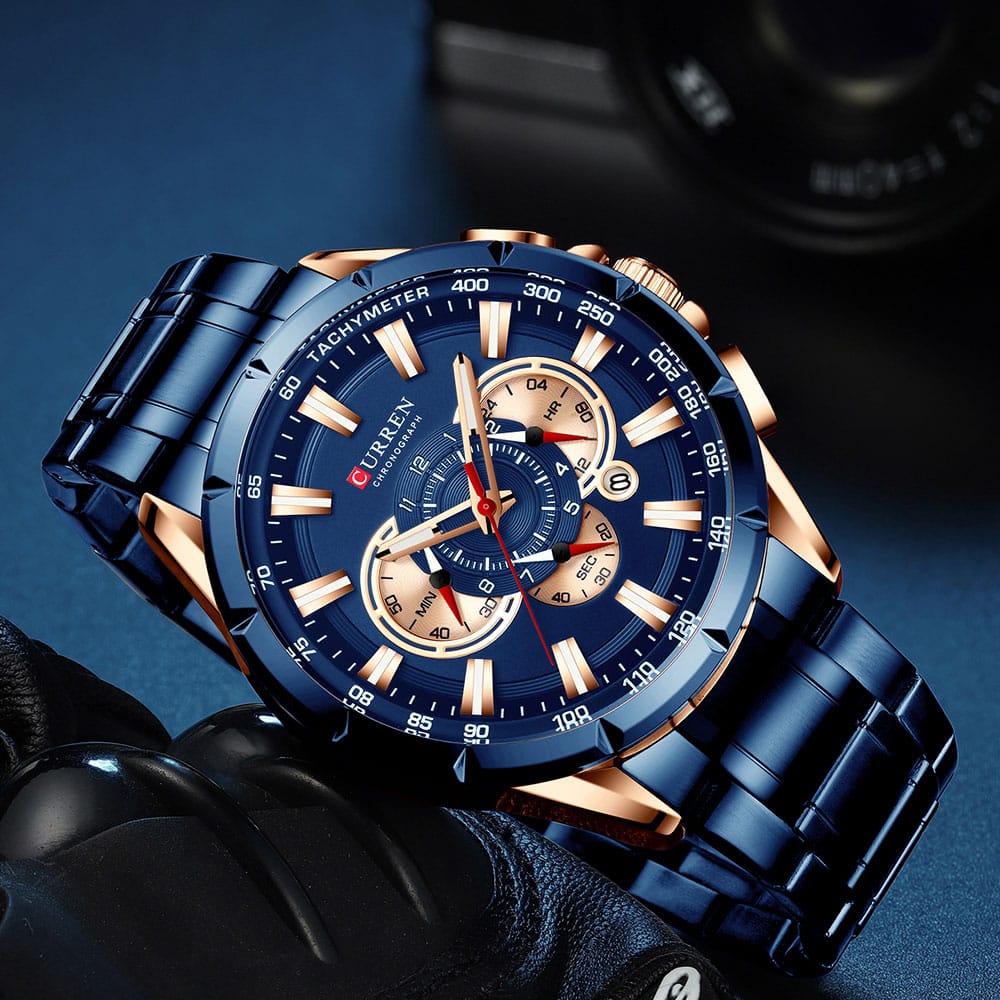 Luxury blue and rose gold watch with detailed face on a dark background