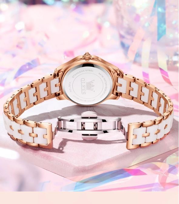 Rose gold and white watch on a colorful background