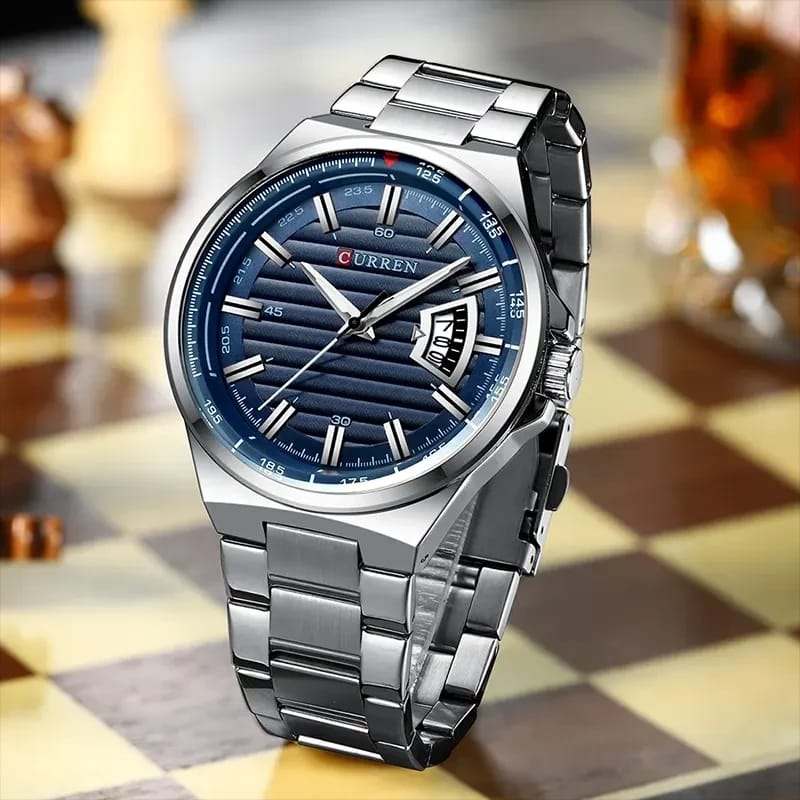 Silver watch with blue dial on a chessboard