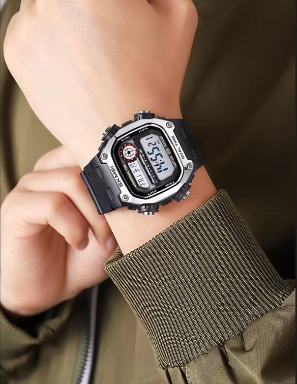 Digital wristwatch on a person's wrist with a green jacket