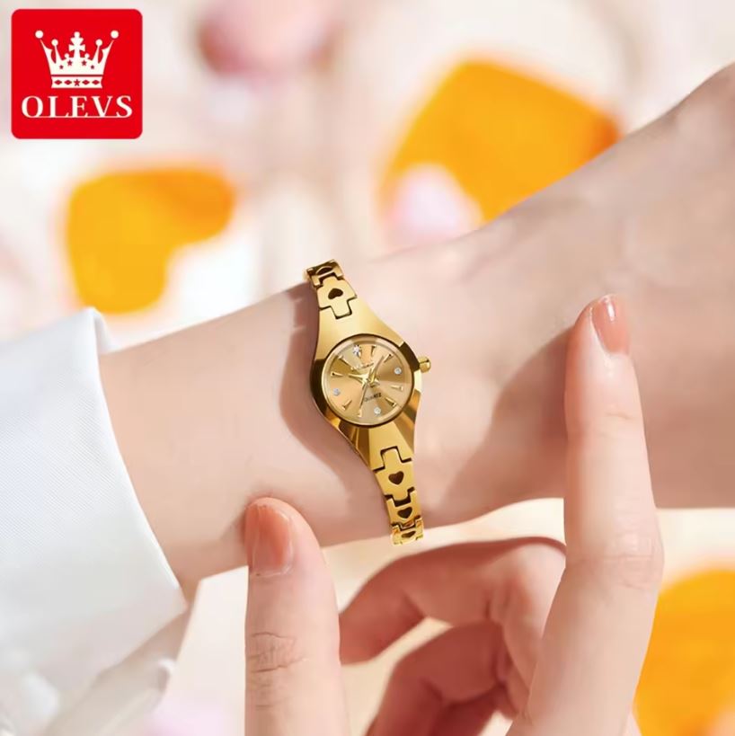 Gold watch on a wrist with a blurred background and OLEVS logo.