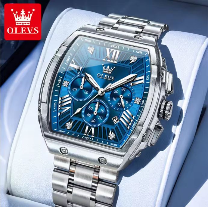Silver watch with blue face on a light blue background, featuring the OLEVS brand.