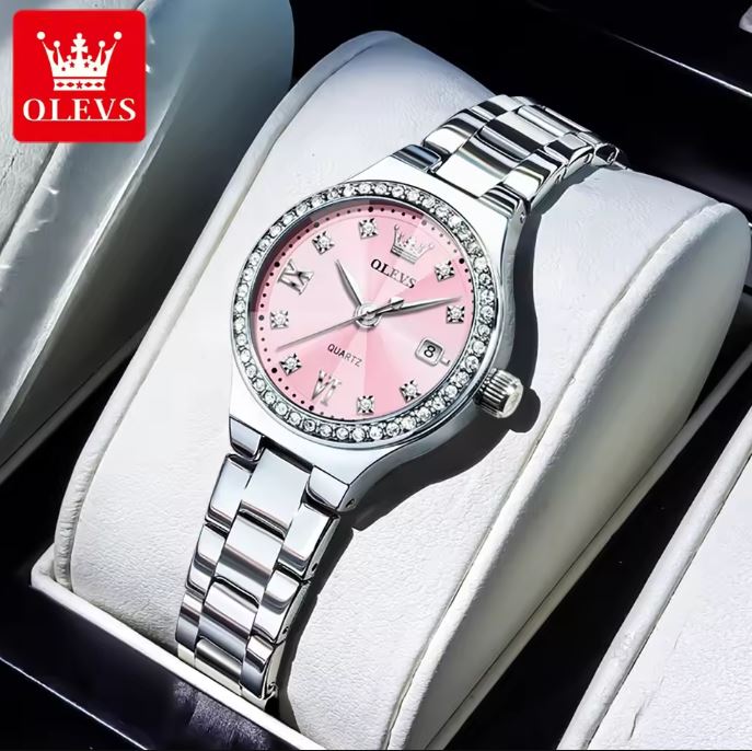 Silver watch with pink dial on a white cushion, brand 'OLEVS' visible