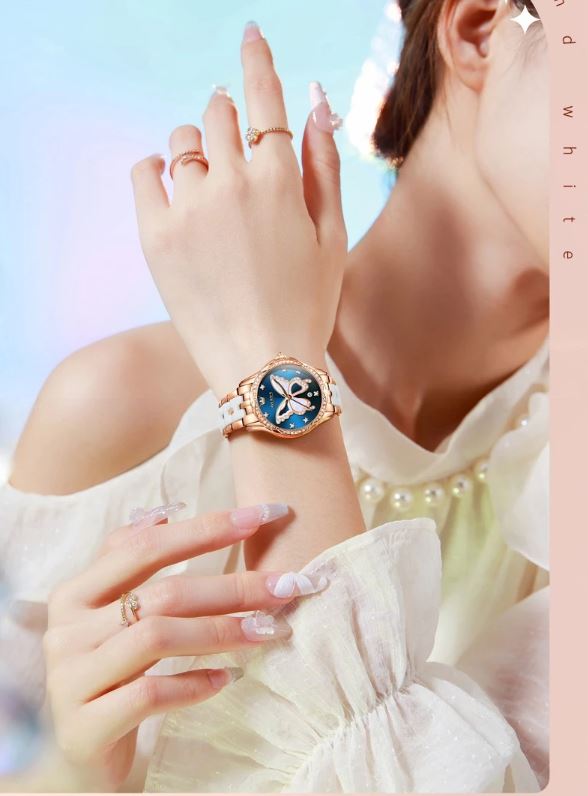 Close-up of a woman's wrist wearing a decorative watch with a blue face and gold casing.