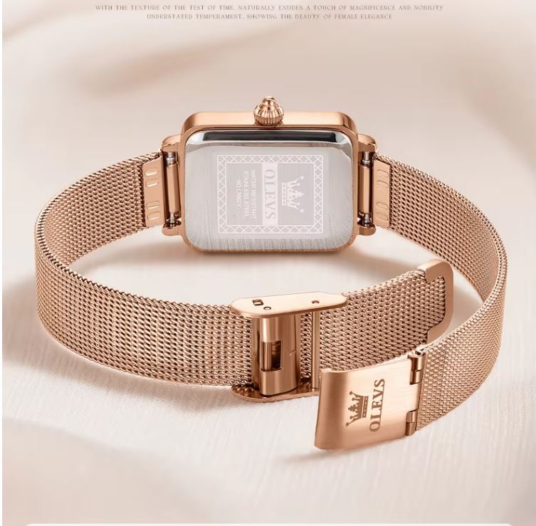 Rose gold watch with mesh band on a light background
