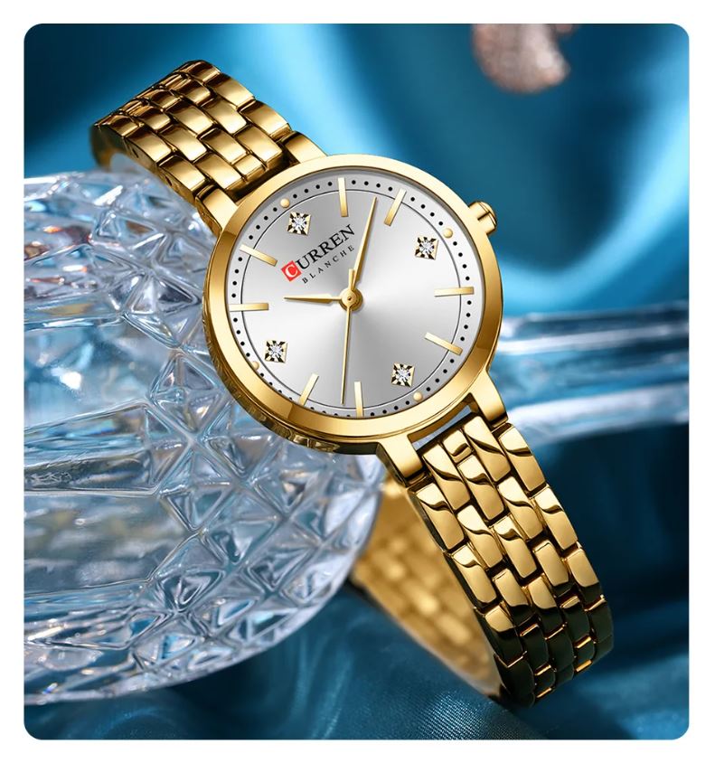 Gold wristwatch with a silver dial on a blue background