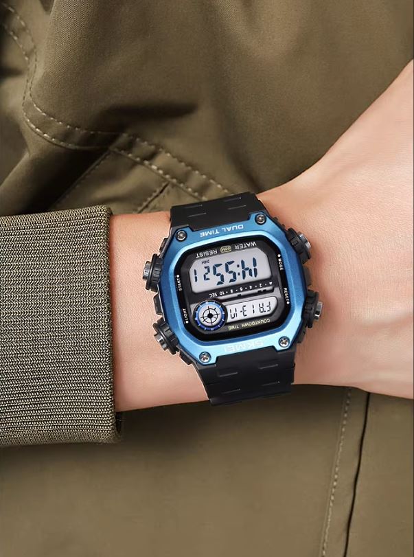 Digital watch on a wrist with a green jacket background