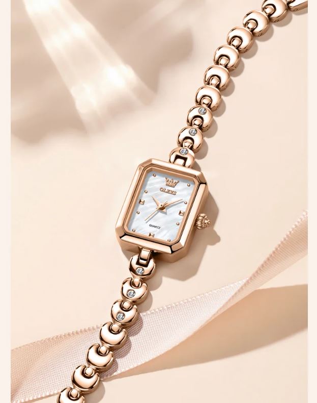 Rose gold watch with diamond-studded bracelet on a soft beige background