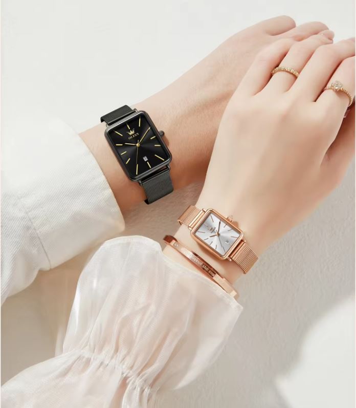 Two watches on wrists against a light background