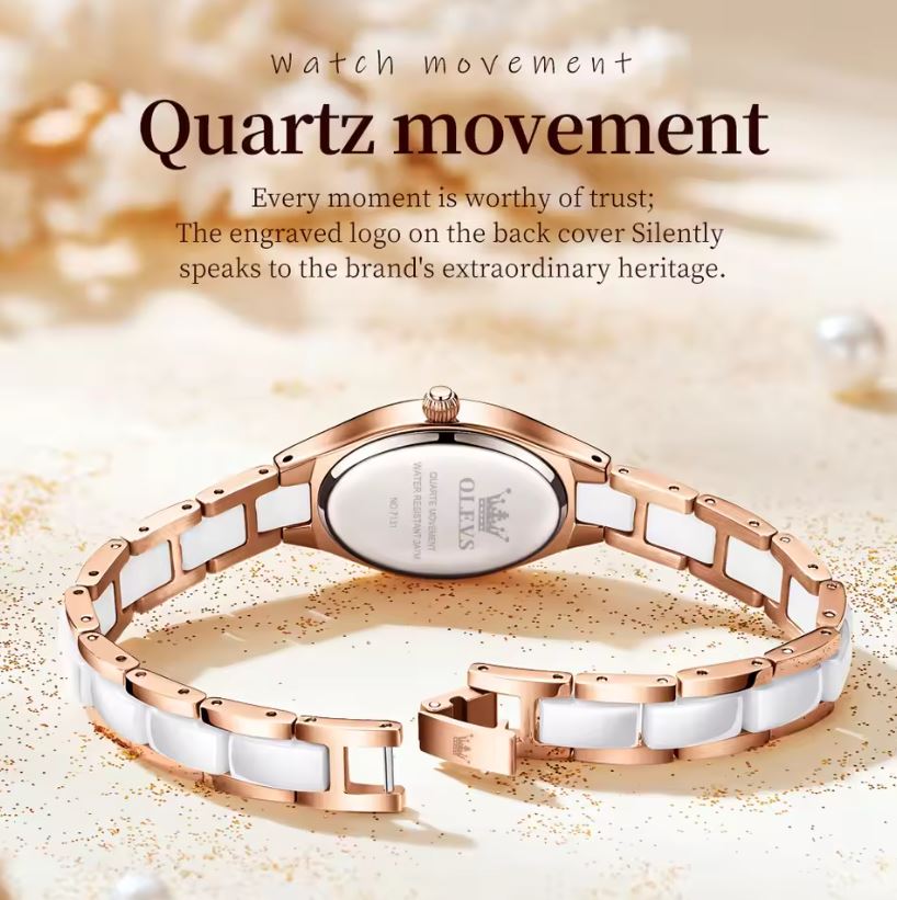 Rose gold and white ceramic watch on a sand-like background with text about quartz movement.