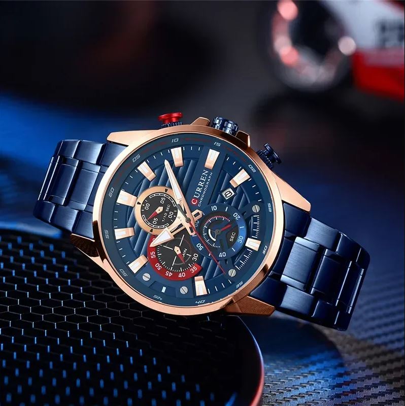 Luxury watch with blue and rose gold design on a dark textured surface