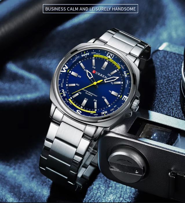 Silver watch with a blue face on a textured surface