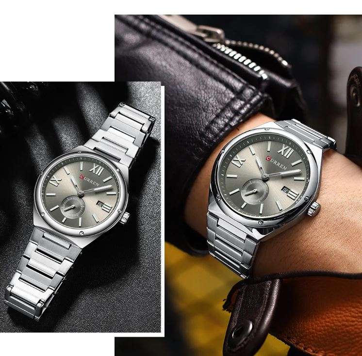 Silver wristwatch on a hand with close-up of watch face, against a dark textured background.