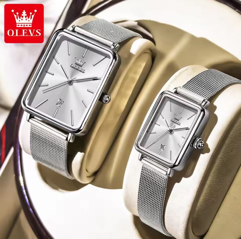 Two silver watches with mesh straps on a decorative background, featuring the OLEVS brand.